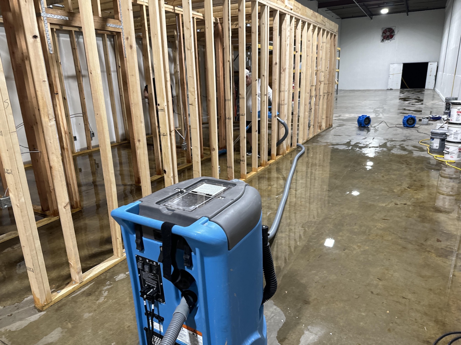 Commercial framing exposed and saturated after storm intrusion in Portland