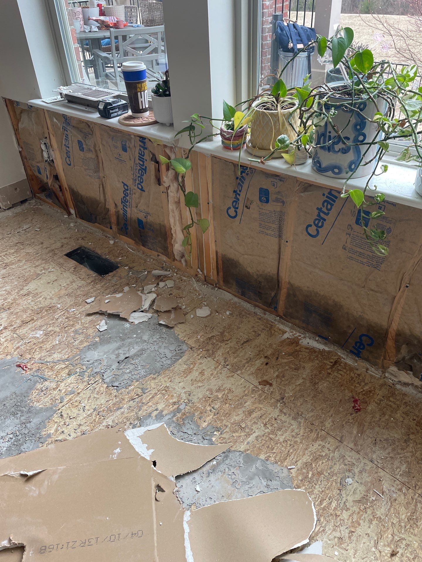 Damaged wall insulation and subfloor after storm damage in Portland