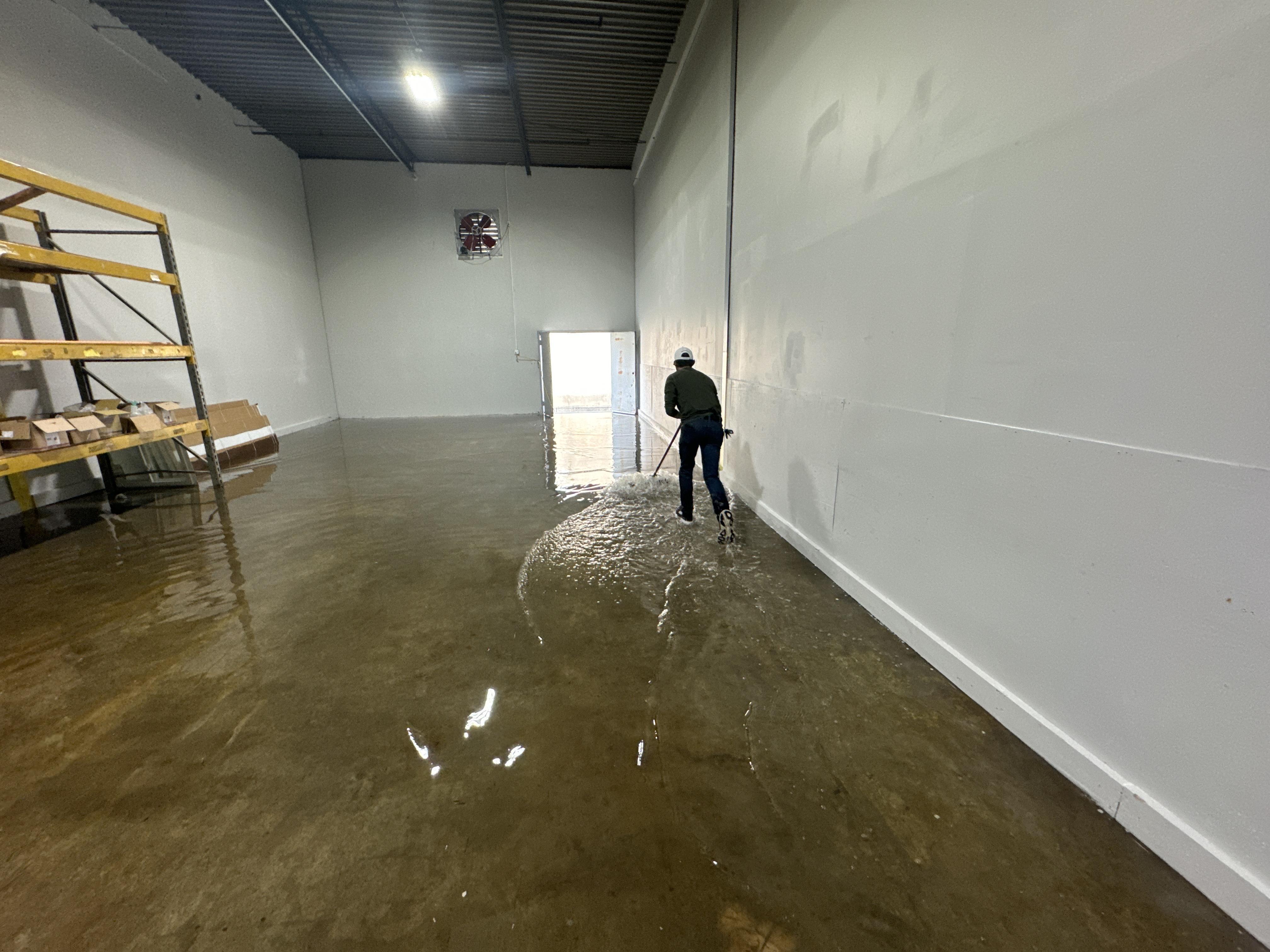 IRS crew member extracting standing water from a Portland commercial building